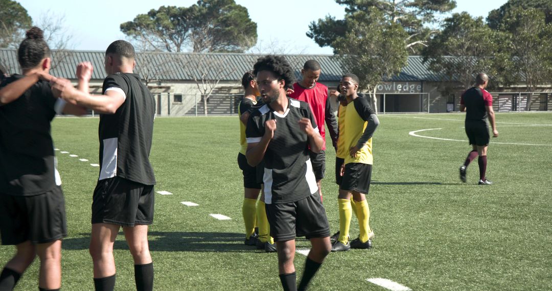 Soccer Team Huddling on Field for Match Strategy and Teamwork