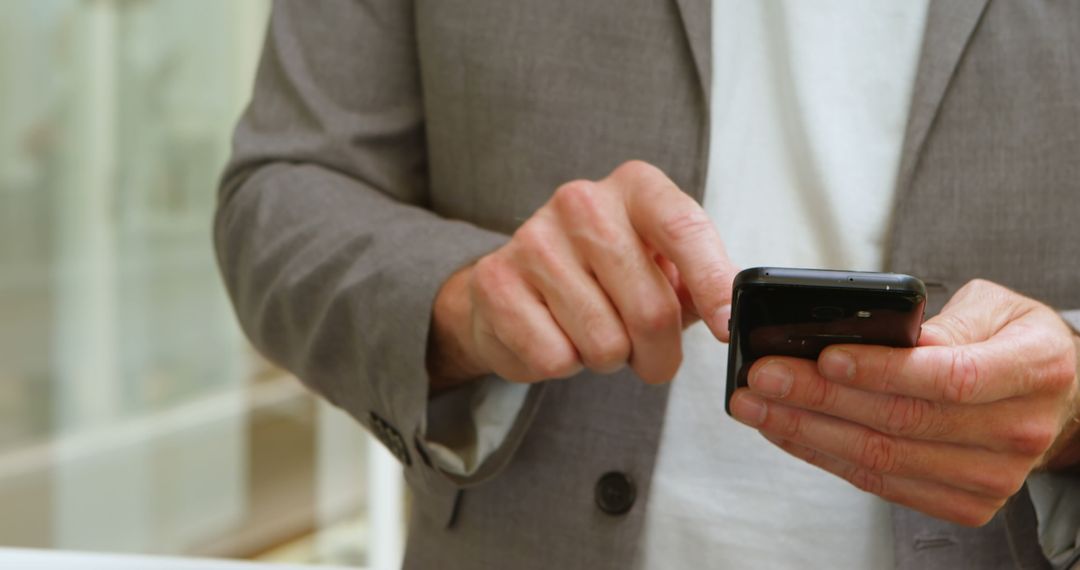 Businessman Using Smartphone in Office Environment - Free Images, Stock Photos and Pictures on Pikwizard.com