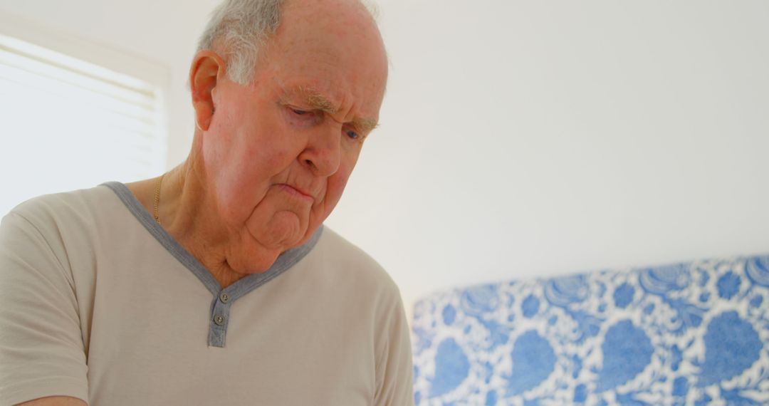 Elderly Man Contemplating Thoughtfully in Bedroom - Free Images, Stock Photos and Pictures on Pikwizard.com