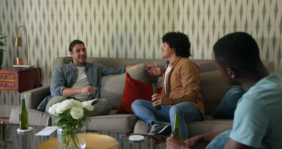 Friends Relaxing on Sofa Enjoying Home Gathering