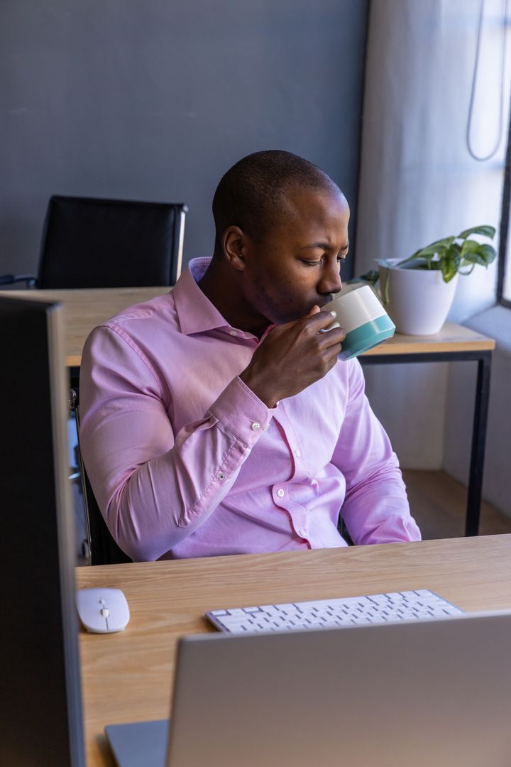 Office Professional Drinking Coffee at Workdesk