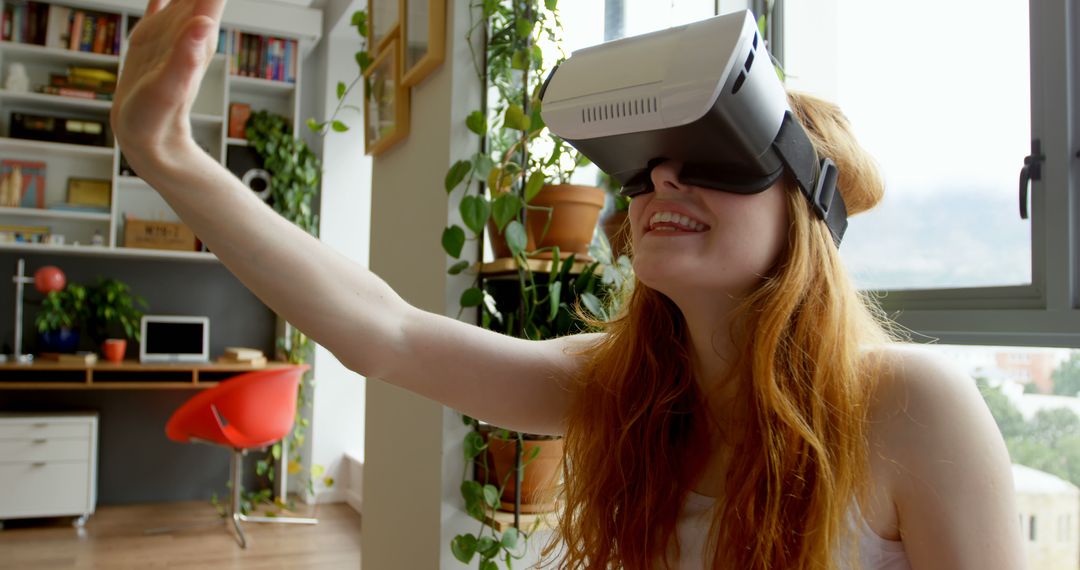 Young Woman Using Virtual Reality Headset in Modern Home - Free Images, Stock Photos and Pictures on Pikwizard.com