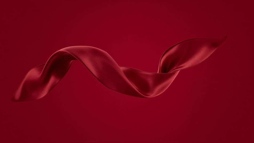 Twisting Red Satin Ribbon Floating on Elegant Dark Background