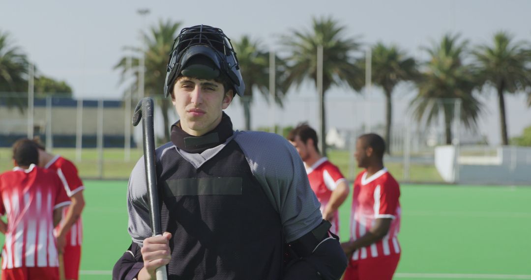 Young Hockey Goalkeeper on Field with Team in Background - Free Images, Stock Photos and Pictures on Pikwizard.com