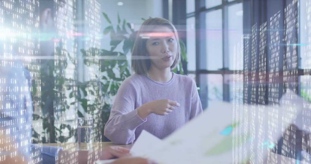 Diverse Business Professionals Engaging in Data Analysis with Digital Overlay