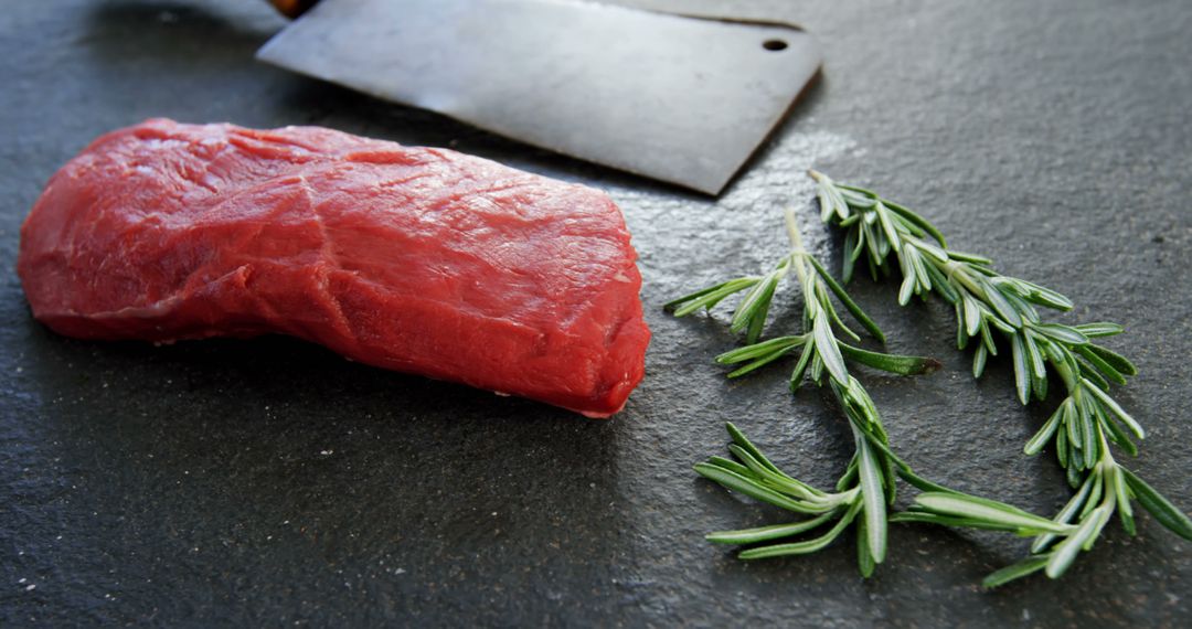 Raw Beef Steak with Fresh Rosemary on Dark Stone Background - Free Images, Stock Photos and Pictures on Pikwizard.com