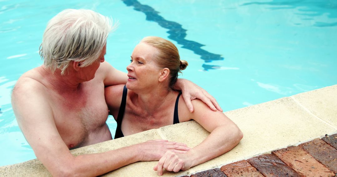 Senior Couple Connecting in Swimming Pool Embracing Leisure - Free Images, Stock Photos and Pictures on Pikwizard.com