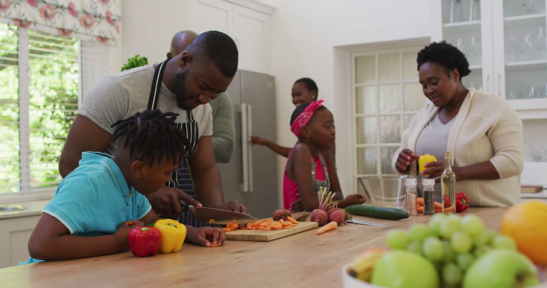 Happy African American Family Preparing Meal Together in Kitchen - Free Images, Stock Photos and Pictures on Pikwizard.com