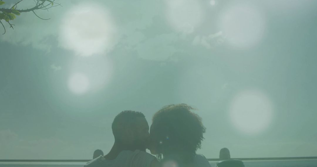 Silhouetted Couple Embracing on Rooftop at Twilight