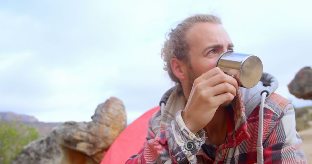 Man drinking coffee at campsite during outdoor adventure - Free Images, Stock Photos and Pictures on Pikwizard.com