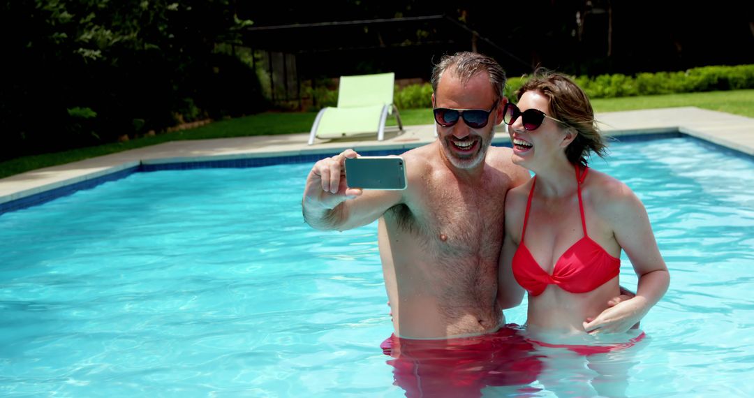 Happy Couple Taking Selfie While Relaxing in Swimming Pool - Free Images, Stock Photos and Pictures on Pikwizard.com