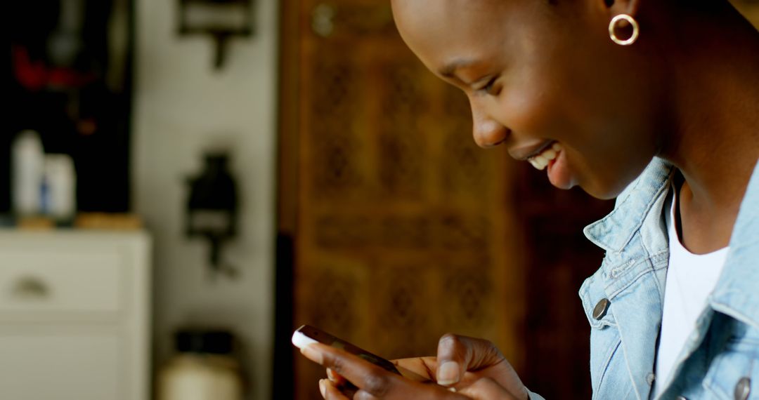 Smiling Woman Checking Smartphone Indoors - Free Images, Stock Photos and Pictures on Pikwizard.com