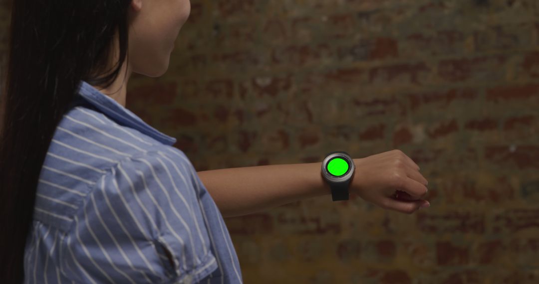 Woman Using Smartwatch with Green Screen for Customization - Free Images, Stock Photos and Pictures on Pikwizard.com