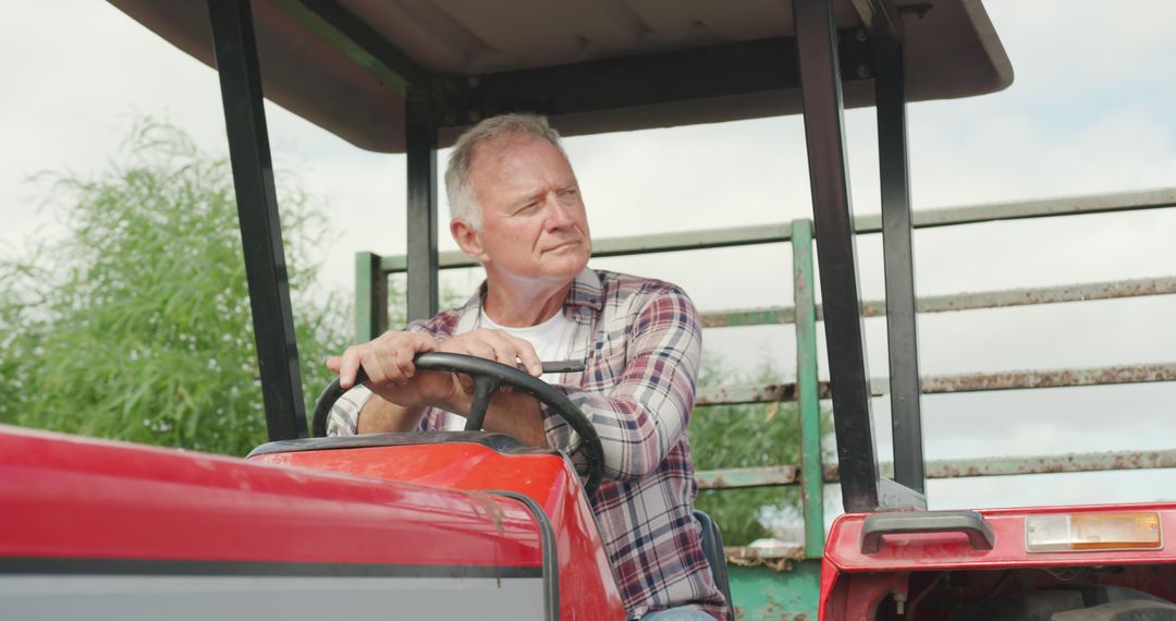 Senior Farmer Driving Tractor on Sunny Day - Free Images, Stock Photos and Pictures on Pikwizard.com