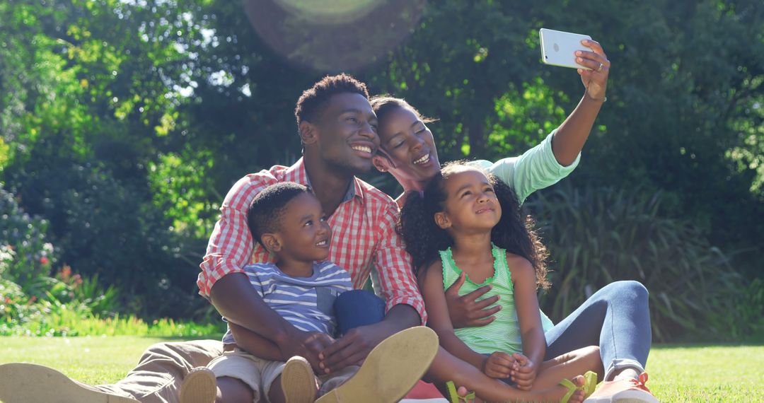 Happy Family Taking Selfie in Sunny Park - Free Images, Stock Photos and Pictures on Pikwizard.com