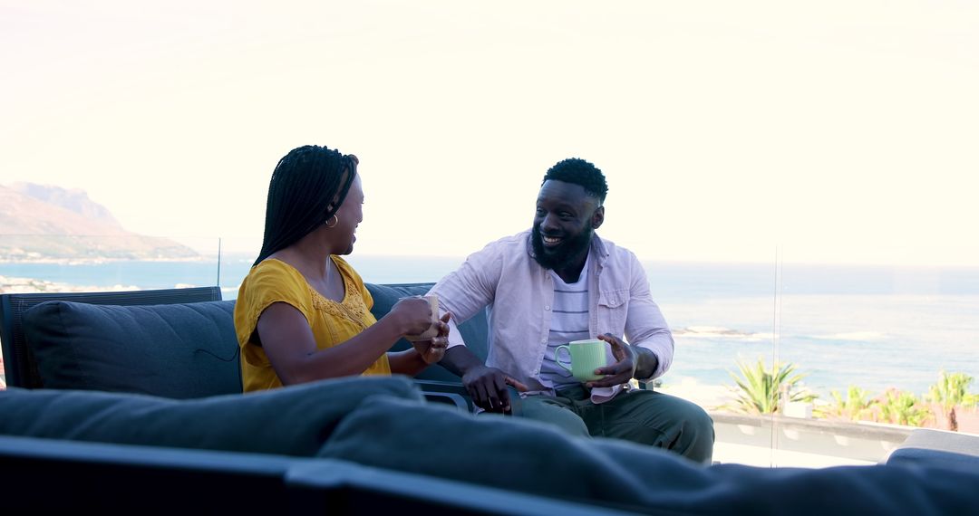 Couple Enjoying Coffee and Smartphone on Balcony with View