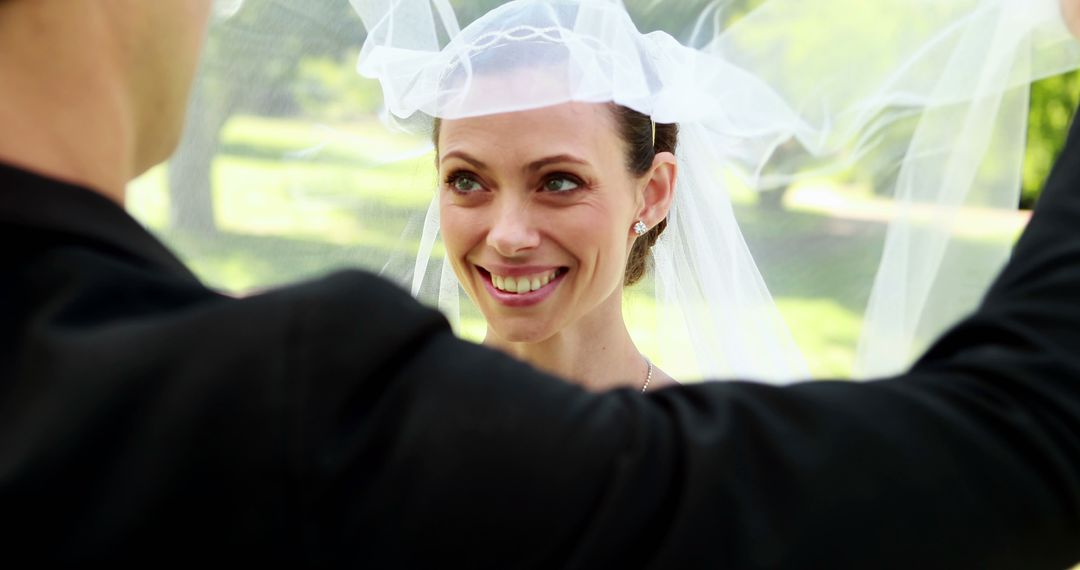 Groom Lifting Bride's Veil Outdoors Wedding Ceremony - Free Images, Stock Photos and Pictures on Pikwizard.com