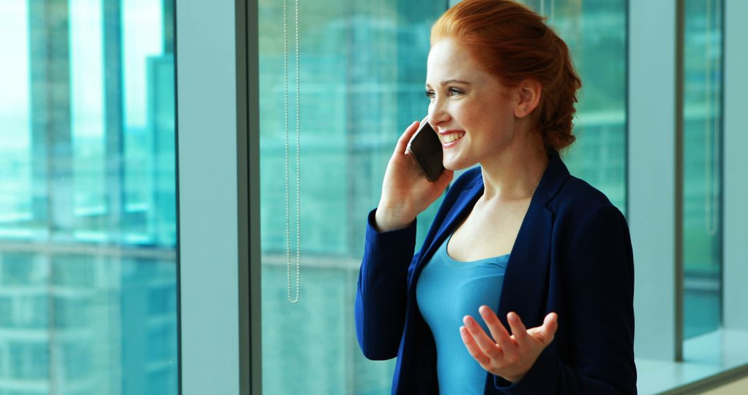 Young Businesswoman Talking on Phone by Office Window - Free Images, Stock Photos and Pictures on Pikwizard.com