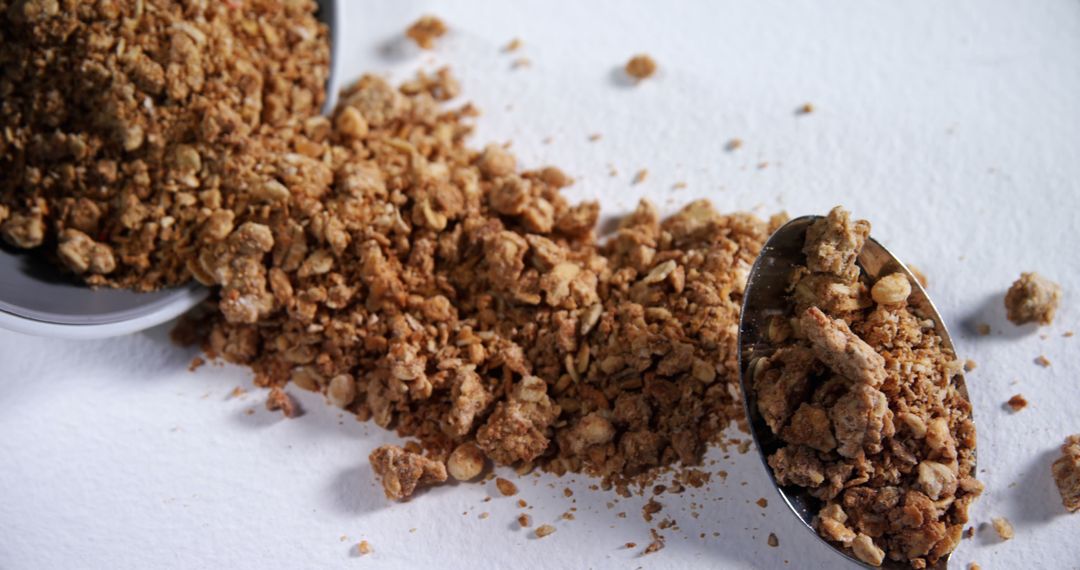 Close-Up of Crumbled Granola with Spoon on White Background - Free Images, Stock Photos and Pictures on Pikwizard.com