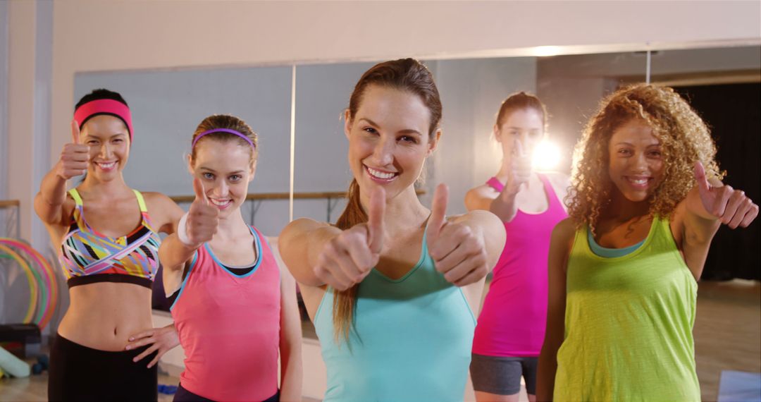 Diverse Women Giving Thumbs Up in Fitness Class, Encouraging Personal Goals - Free Images, Stock Photos and Pictures on Pikwizard.com