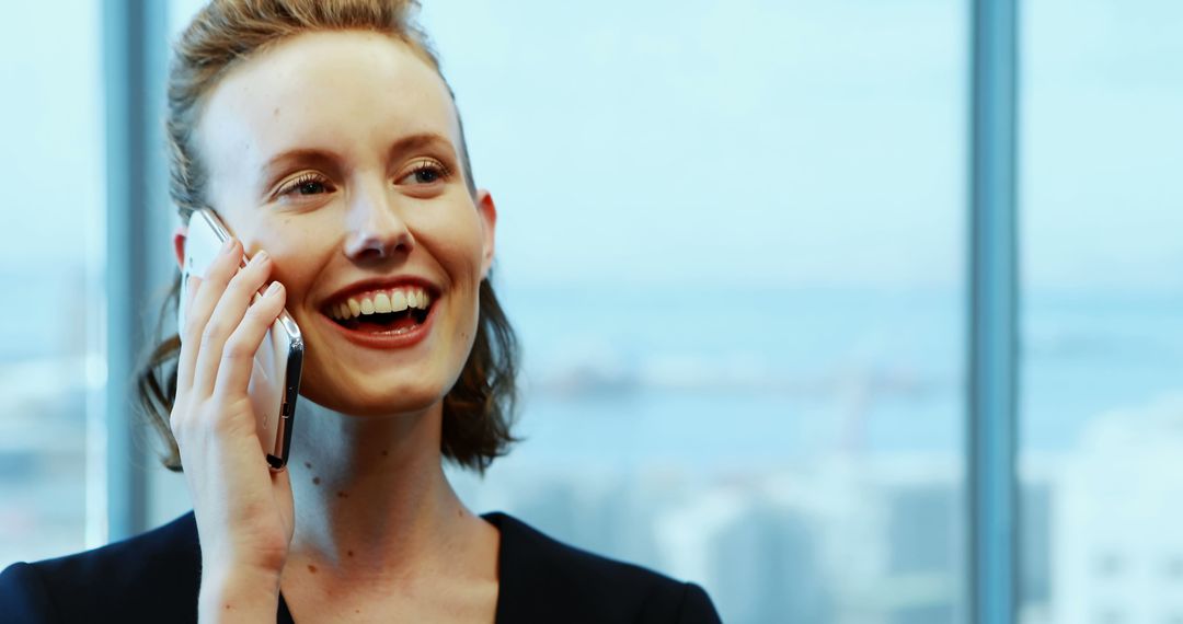 Smiling Businesswoman on Phone Call with City View Background - Free Images, Stock Photos and Pictures on Pikwizard.com