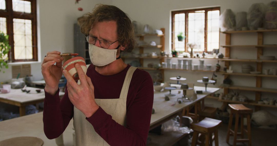 Artist Crafting Pottery with Paint Brush in Ceramic Studio - Free Images, Stock Photos and Pictures on Pikwizard.com