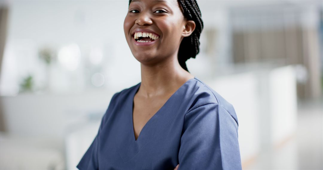 Smiling Healthcare Professional in Blue Scrubs Standing Confidently - Free Images, Stock Photos and Pictures on Pikwizard.com