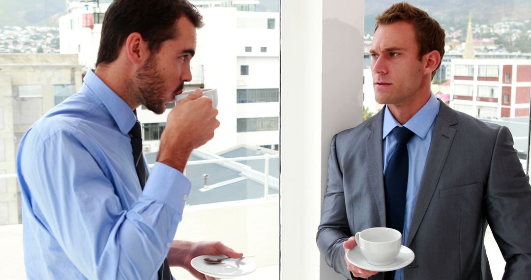 Businessmen taking a break with coffee discussing work - Free Images, Stock Photos and Pictures on Pikwizard.com