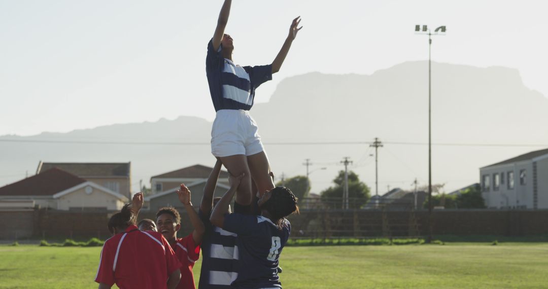 Youth Rugby Players Lifting Teammate for Lineout Throw on Sunlit Field - Free Images, Stock Photos and Pictures on Pikwizard.com