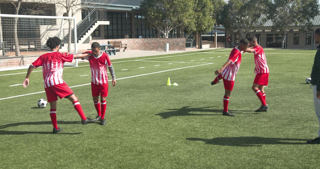 Teen Soccer Players Practicing with Coach on Field