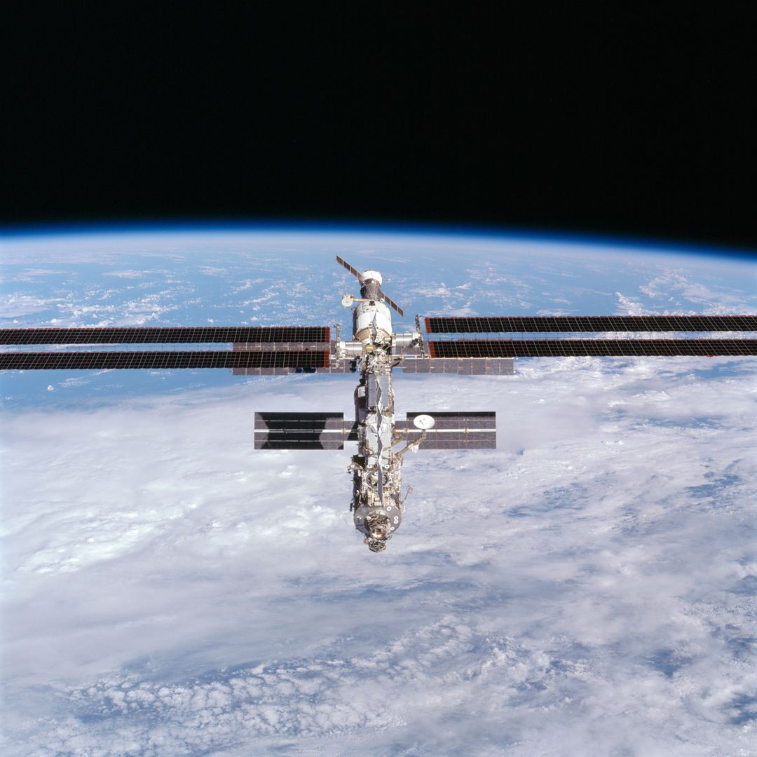 International Space Station Orbiting Earth with Deployed Solar Panels - Free Images, Stock Photos and Pictures on Pikwizard.com