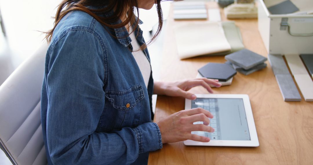 Woman Using Tablet at Office Desk During Workday - Free Images, Stock Photos and Pictures on Pikwizard.com