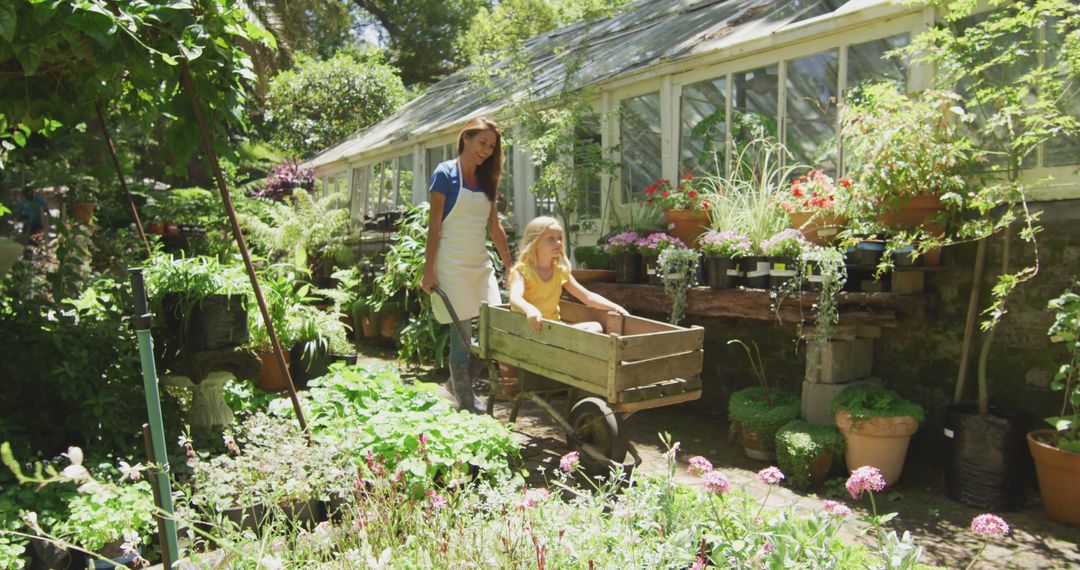 Mother and Daughter Gardening Together in Lush Greenhouse - Free Images, Stock Photos and Pictures on Pikwizard.com