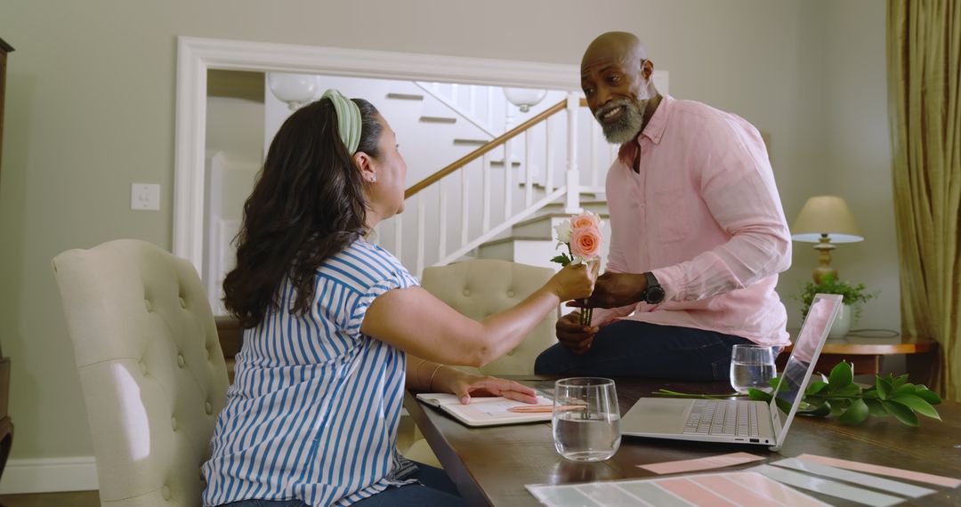Senior Diverse Couple Sharing Flowers in Loving Home Environment