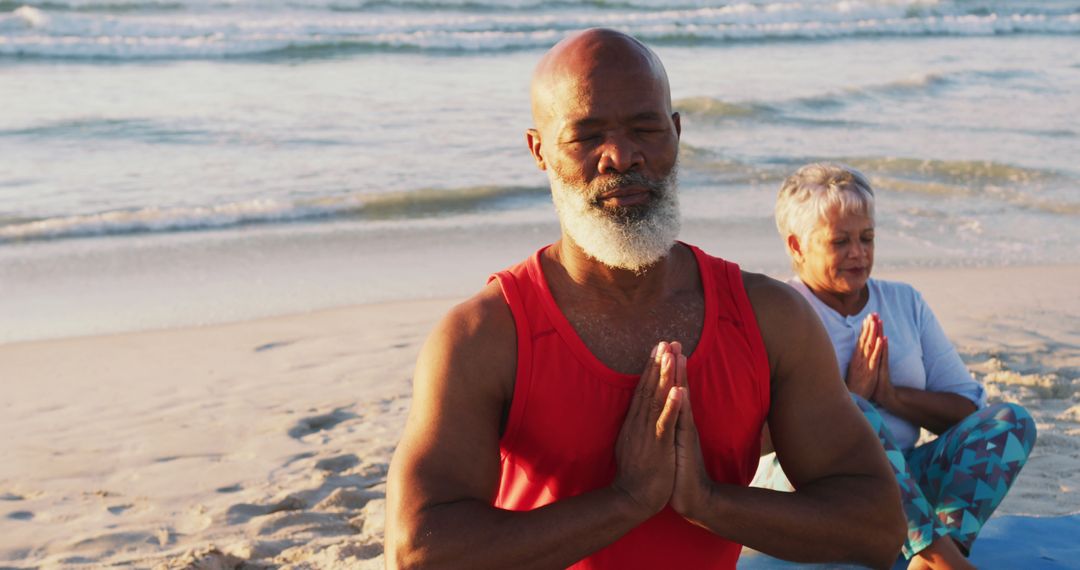 Senior african american couple practising yoga at the beach - Free Images, Stock Photos and Pictures on Pikwizard.com