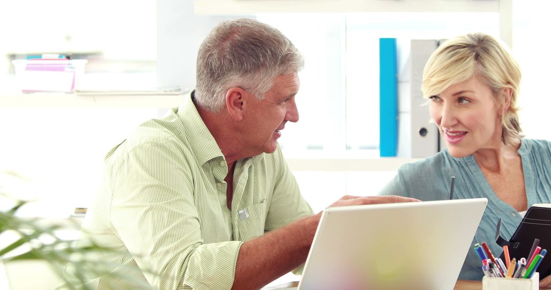 Middle-Aged Professionals Collaborating in Bright Office Setting