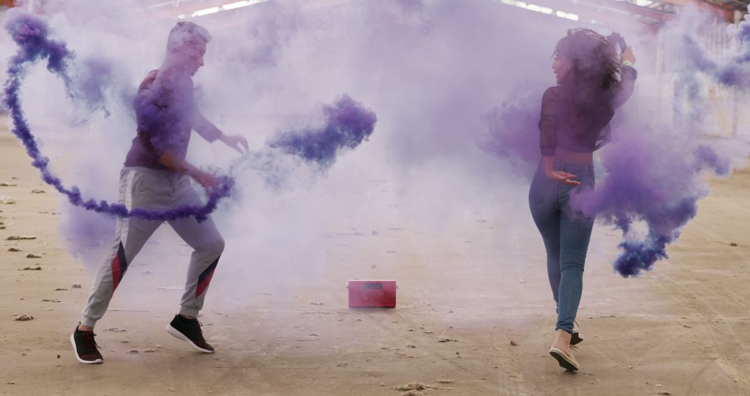 Two People Playing with Purple Smoke Bomb in Abandoned Building - Free Images, Stock Photos and Pictures on Pikwizard.com