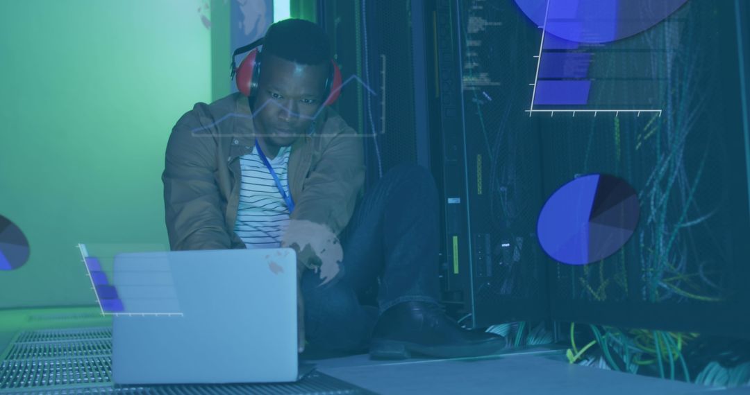 African American IT Professional Working on Data Amidst Servers and Charts
