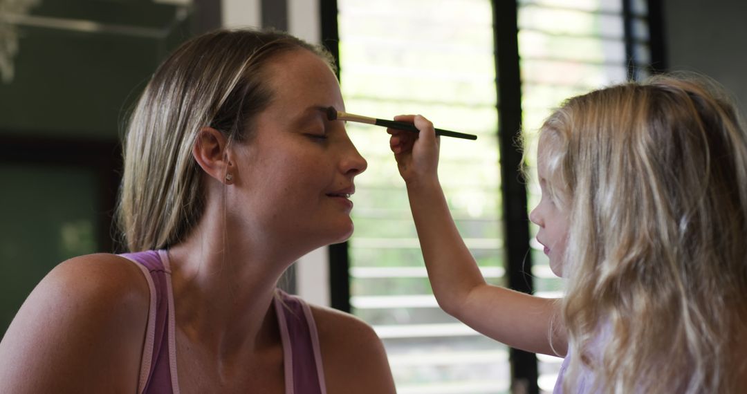 Joyful Moment Between Mother and Daughter Applying Makeup at Home - Free Images, Stock Photos and Pictures on Pikwizard.com