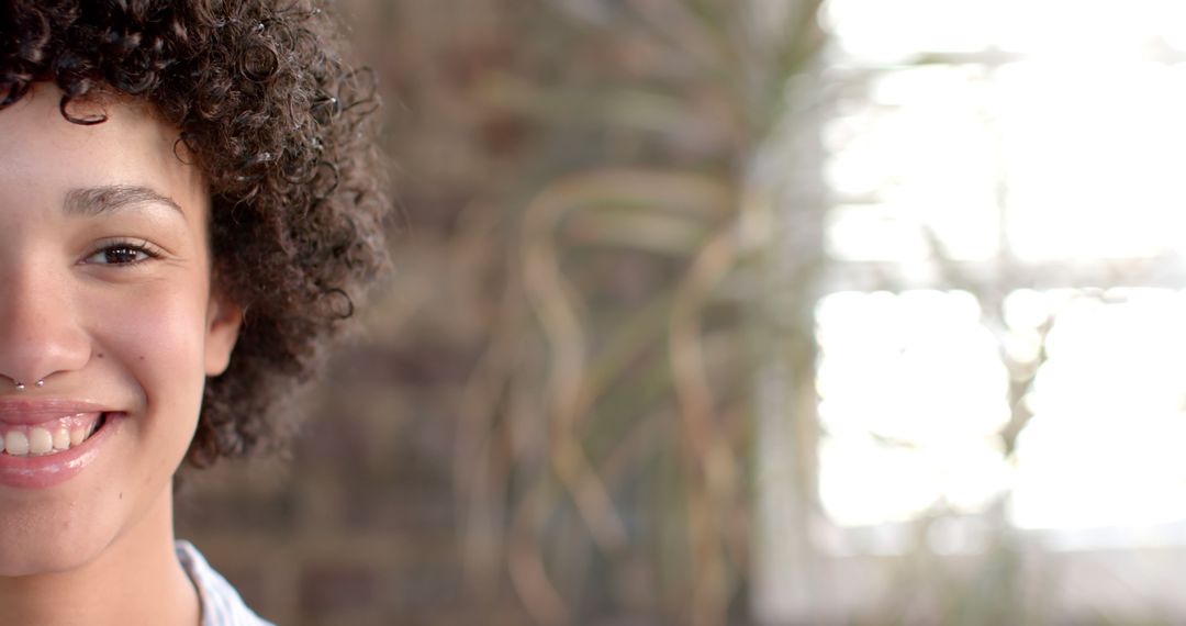 Half Face of Smiling Curly-Haired Person with Blurred Background - Free Images, Stock Photos and Pictures on Pikwizard.com