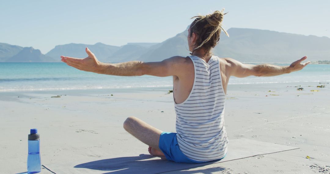 Man Practicing Yoga Meditation on Beach with Ocean View - Free Images, Stock Photos and Pictures on Pikwizard.com