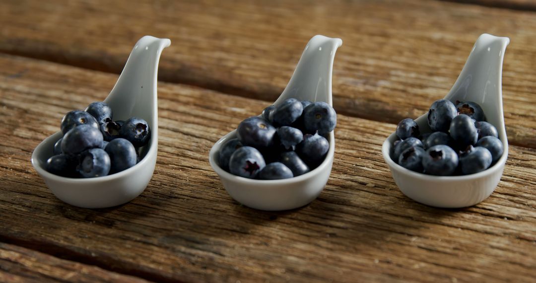 Fresh Blueberries in Small Ceramic Spoon Rests - Free Images, Stock Photos and Pictures on Pikwizard.com