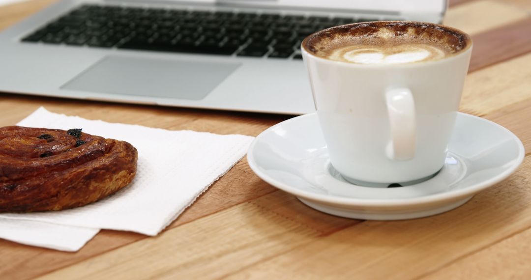 Coffee Break with Laptop and Pastry in Cozy Workspace - Free Images, Stock Photos and Pictures on Pikwizard.com