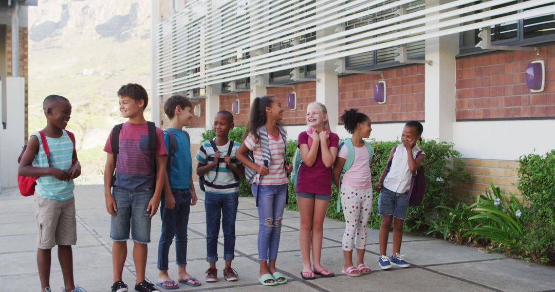 Diverse Schoolchildren with Backpacks in School Yard