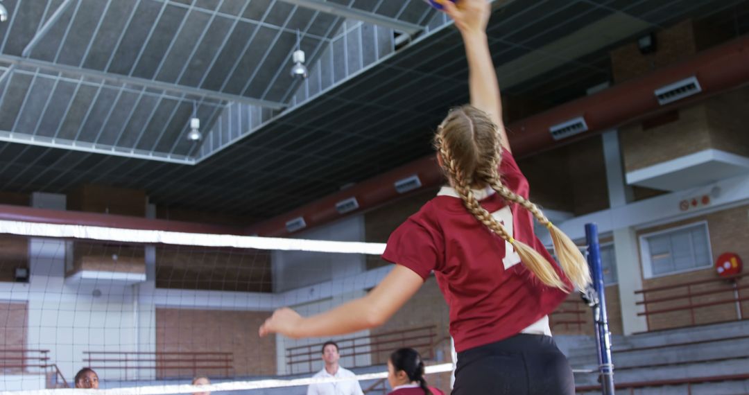 Female Volleyball Team Member Spiking Ball in Indoor Gym - Free Images, Stock Photos and Pictures on Pikwizard.com