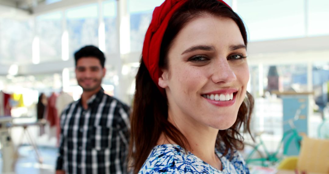 Smiling Woman with Red Headband in Creative Workspace - Free Images, Stock Photos and Pictures on Pikwizard.com