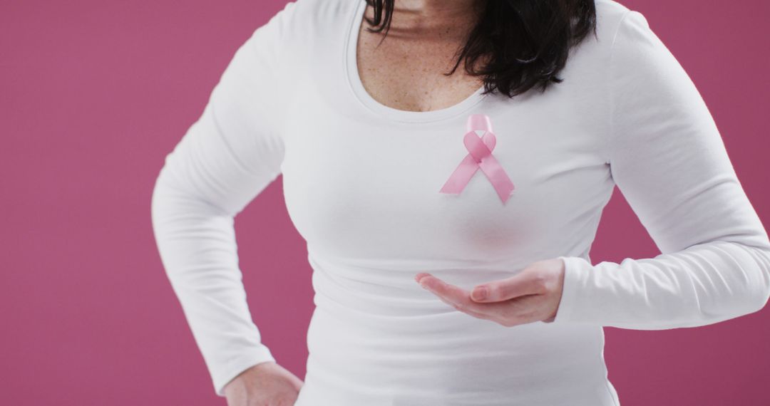 Woman in White Shirt Wearing Pink Ribbon for Breast Cancer Awareness - Free Images, Stock Photos and Pictures on Pikwizard.com