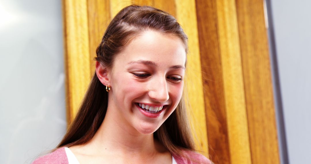 Smiling Young Woman with Brown Hair in Casual Pink Sweater - Free Images, Stock Photos and Pictures on Pikwizard.com