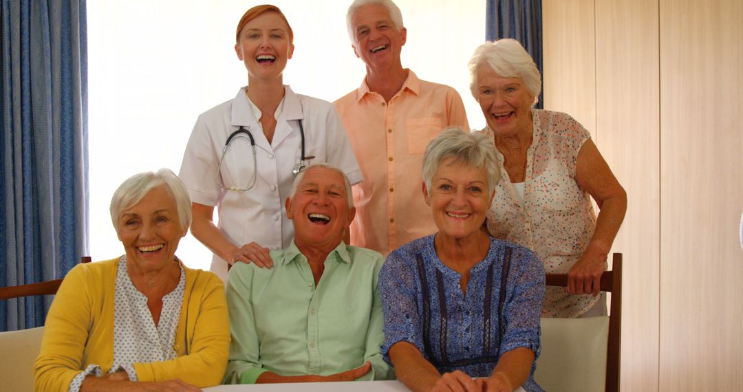 Happy Seniors Group Celebrating with Caregiver in Comforting Environment - Free Images, Stock Photos and Pictures on Pikwizard.com