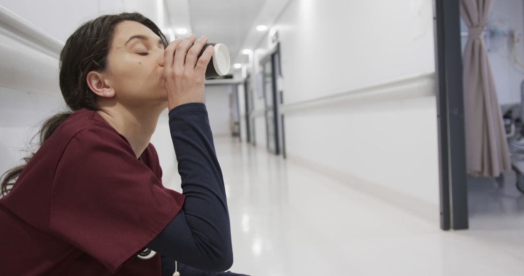 Healthcare Worker Taking a Break in Hospital Corridor - Free Images, Stock Photos and Pictures on Pikwizard.com